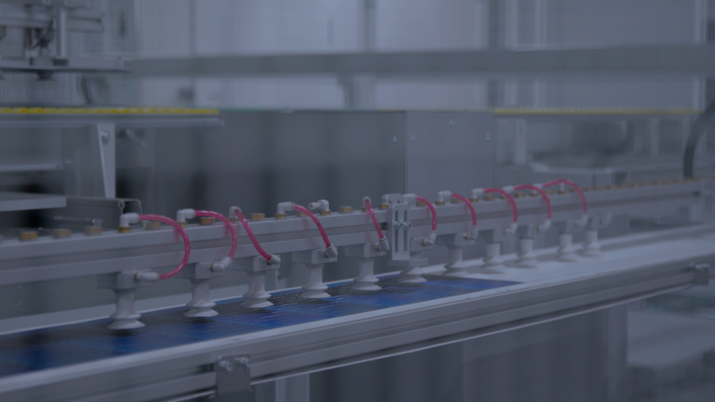 Cell handling system transporting solar cells inside an automated solar production line.