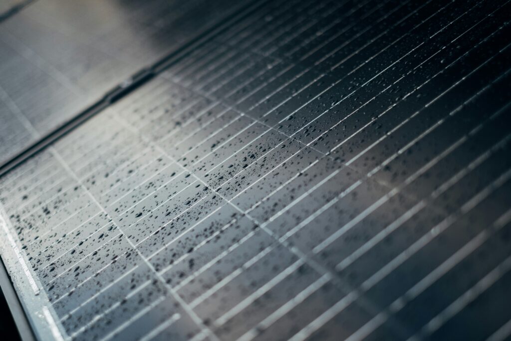 Close-up of a photovoltaic module showing the glass surface and solar cells used in PV panel recycling processes.