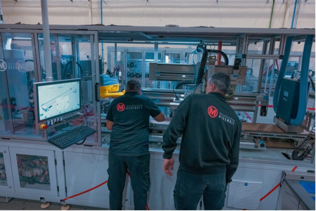 : Technician performing preventive maintenance on automated solar panel manufacturing equipment in a photovoltaic module production line.